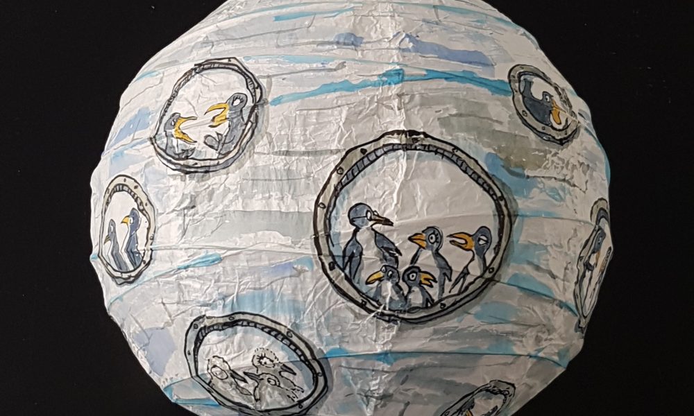 Drawing of a group of penguins inside a sphere ice submarine, painted on rice paper lamp. art by Frits Ahlefeldt