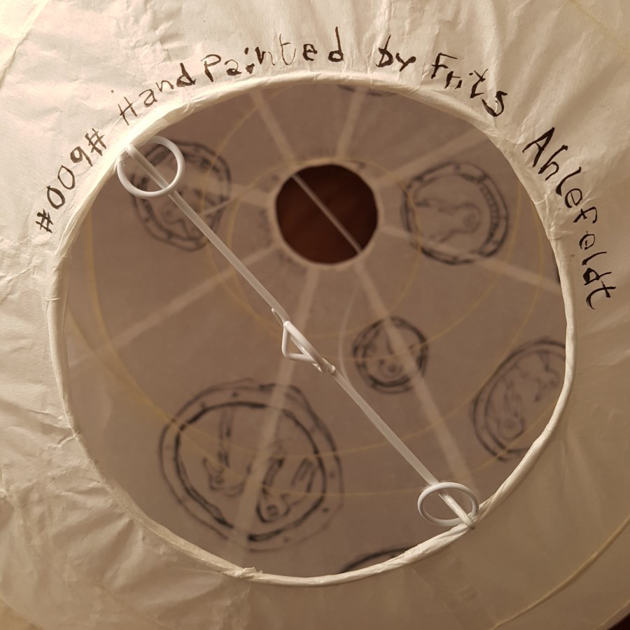 Drawing of a group of penguins inside a sphere ice submarine, painted on rice paper lamp. art by Frits Ahlefeldt